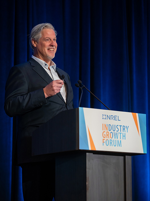 20250421-record-attendance-at-30th-annual-nrel-industry-growth-forum-as-innovation-soars-bob-oconnor A man stands behind a podium labeled with Industry Growth Forum.