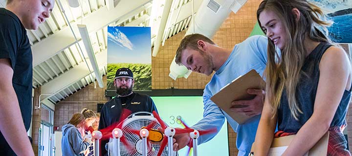 Teachers at a hands-on wind experiment.