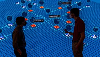 Researchers discuss a large projection of a power grid.