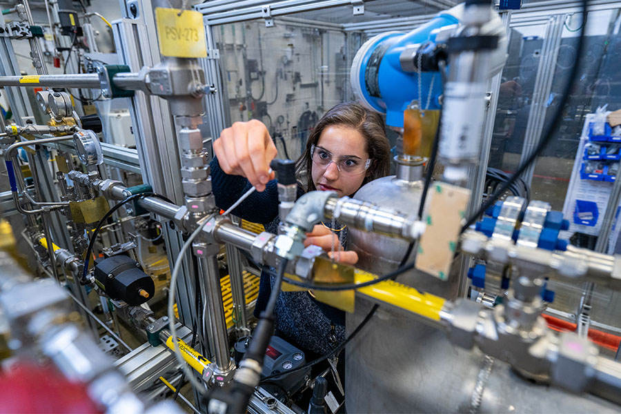 Researcher works on hydrogen electrolyzer stack test bed.