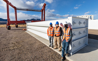 photo of individuals in front of fuel cells