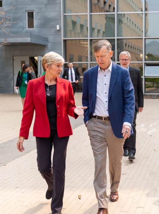 Two people walking outside RSF building.