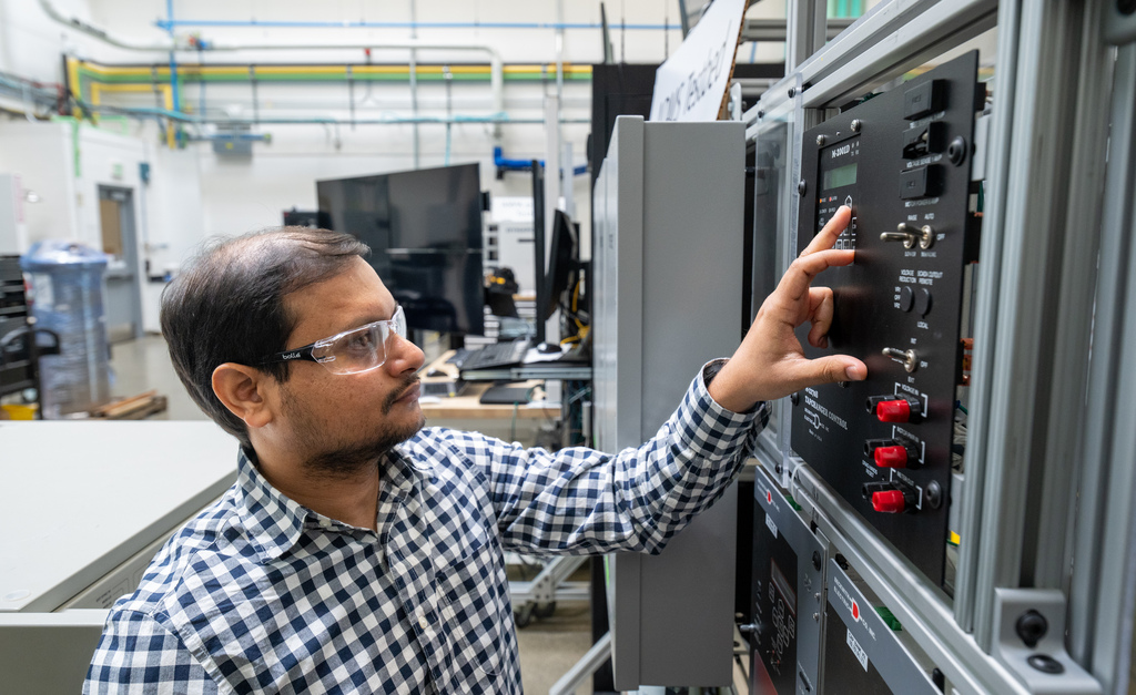 Photo of a person pushing buttons inside a facility