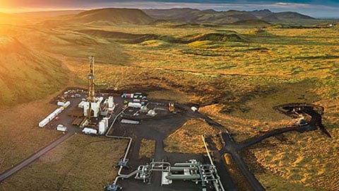 Aerial view of geothermal energy plant at sunrise