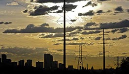 Transmission lines near a city skyline.