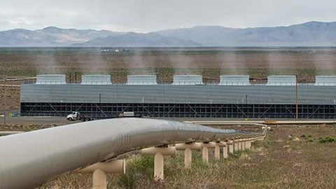 Long tube goes into the ground with steam coming out