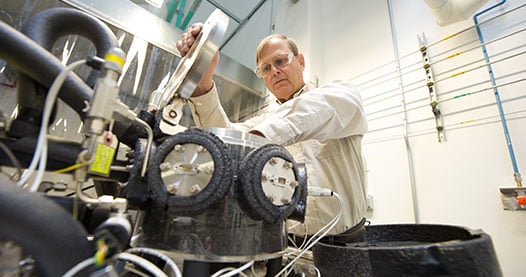 Photo of a researcher working with sensor testing equipment in a laboratory