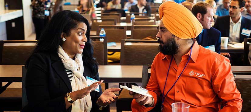 Two people talking at a conference