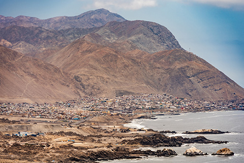 nzw-priority-focus-areas Photo of Tocopilla, Chile, where you can see a mountainous region abutting the ocean.