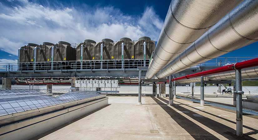 research-chp-26208-lg A photo of large metal pipes next to skylights on a roof.