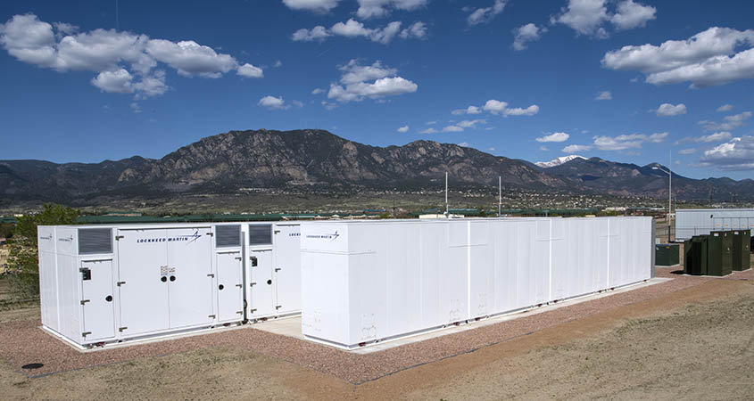 utility-scale-li-battery-energy-storage-dennis-schroeder-nrel-56322-center Two long containers on a field in front of mountains.