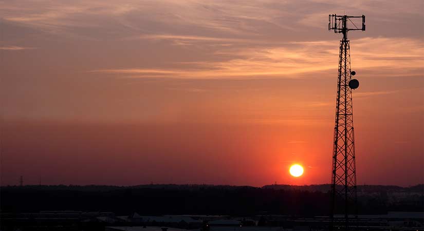 a cell tower at sunset