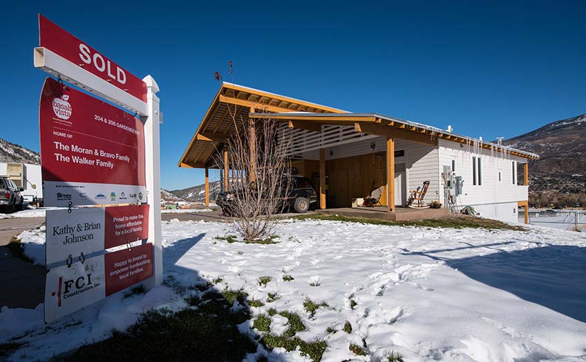 20191210-holycross-60078 Energy efficient home with sold sign in front.