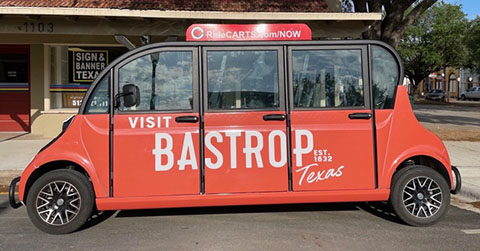 Photo of a red ecab painted with the words