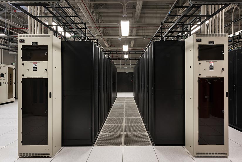 MCAS Miramar server racks line up in alternating rows so that cold air intake and hot air exhausts face opposite directions. Photo from R.A. Burch Construction.
