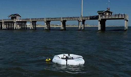 Continue reading about A white circular device in the ocean by a pier at North Carolina's Outer Banks.