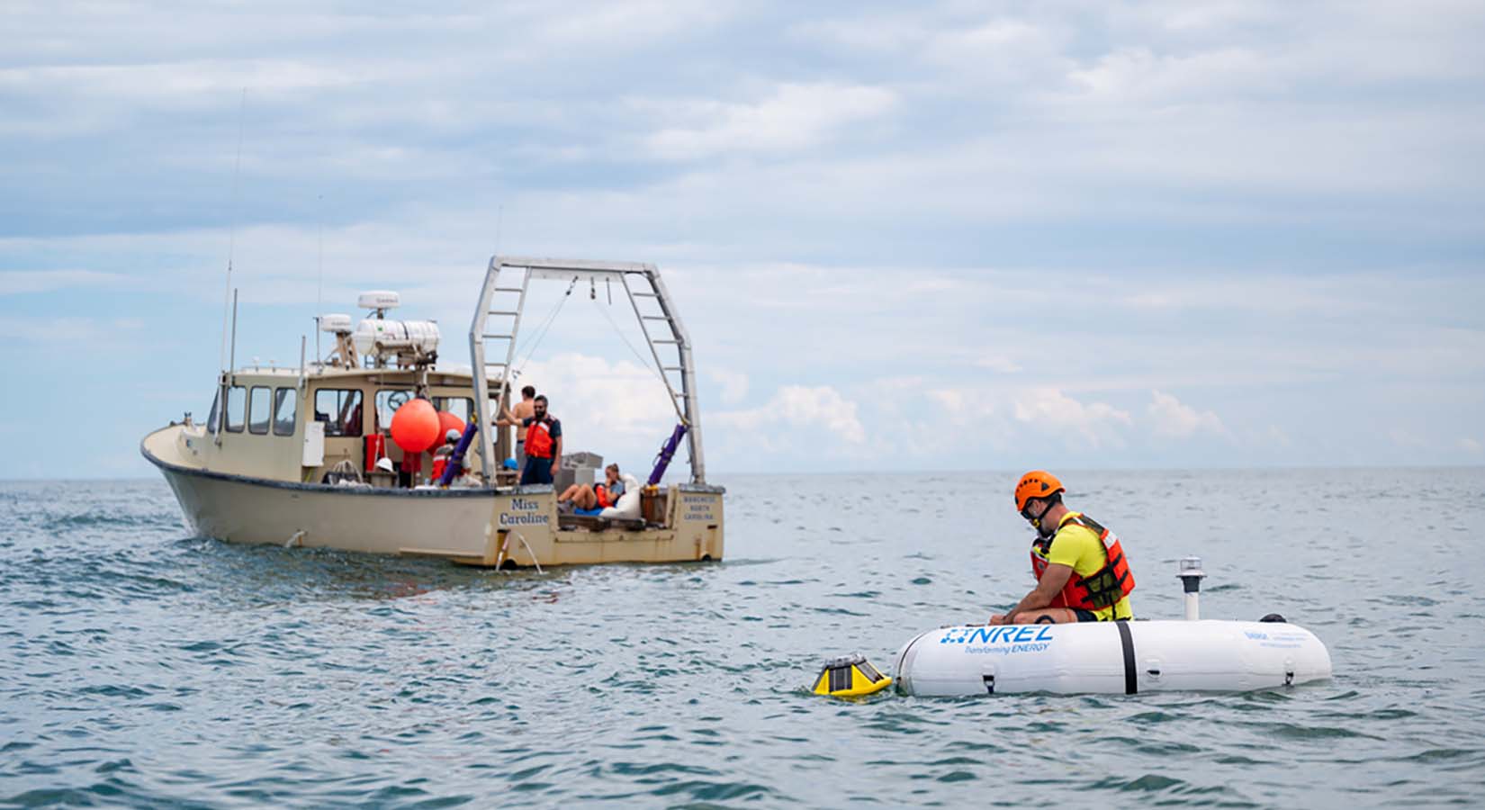 people on a boat and a person in a raft