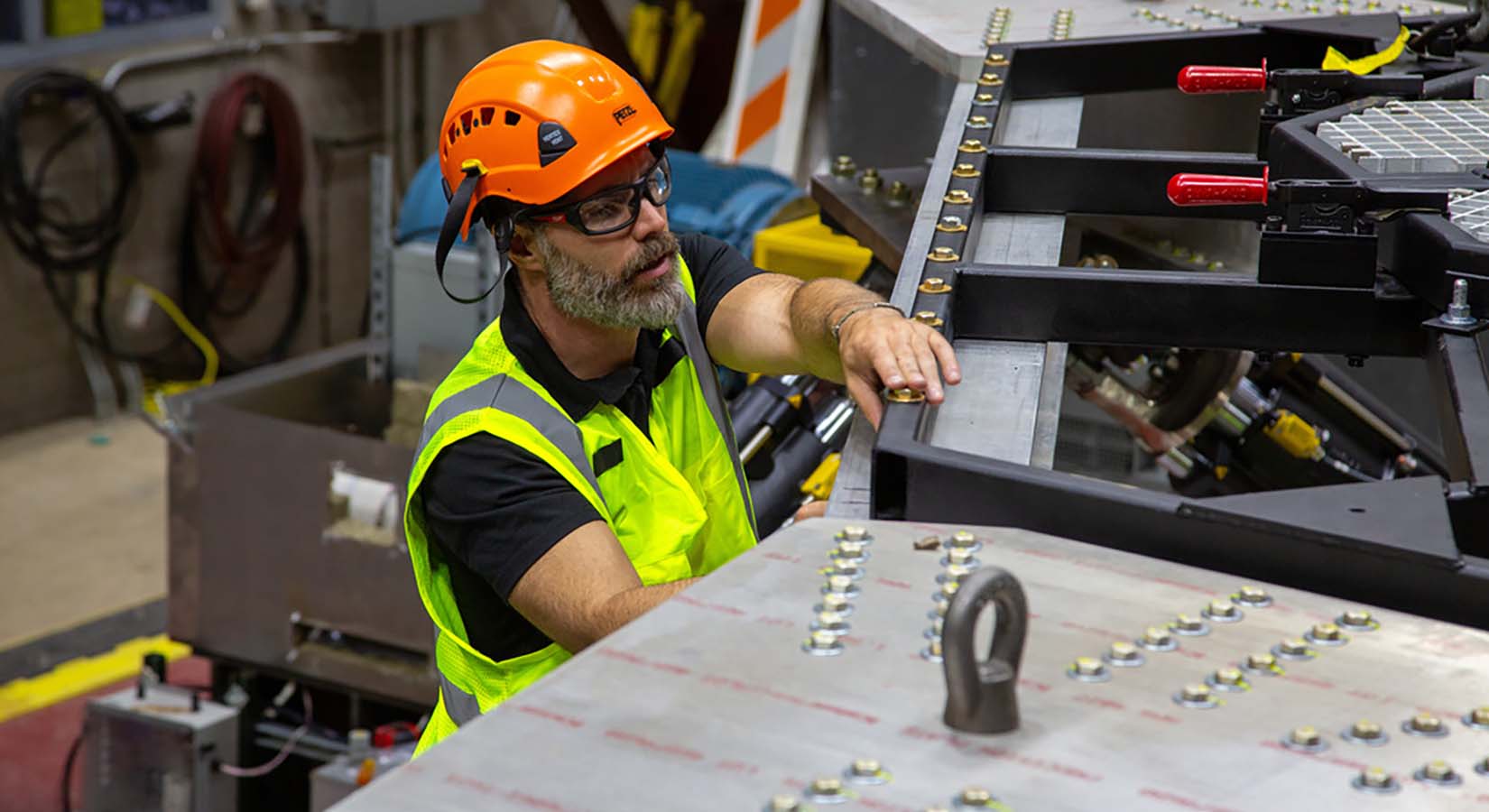 a worker investigating machinery