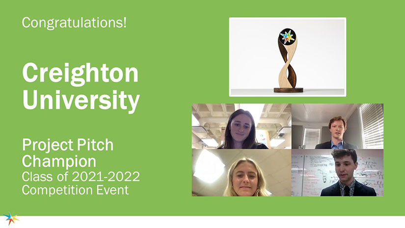 A screenshot of four students and a trophy with text that says