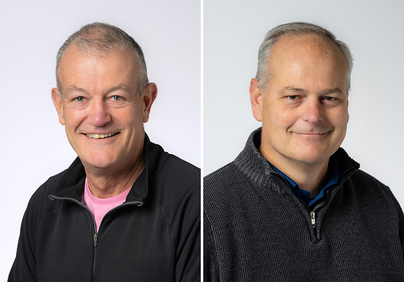 Two men smiling.