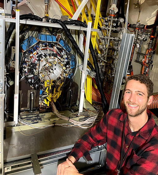 Alec Schnabel sits in front of marine energy technology