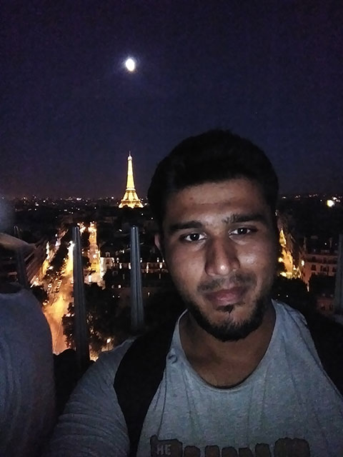 Salman Husain in front of the Eiffel Tower