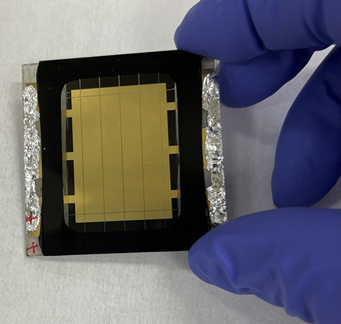 20250429-nrel-led-research-effort-adds-salt-boosts-performance-of-perovskites-solar-cell A gloved hand holds a perovskite solar cell.