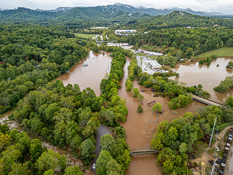 20250506-microgrids-could-enhance-grid-resilience-hurricane-helene-flood-north-carolina An aerial photo of flooding in a mountainous area.