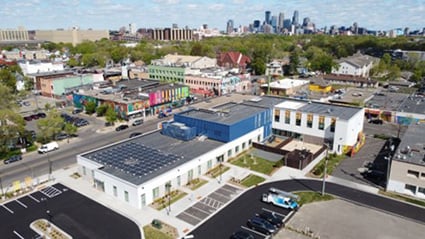 A business community in a low- to moderate-income neighborhood in Minneapolis, Minnesota. Buildings in the foreground have rooftop solar panels.
