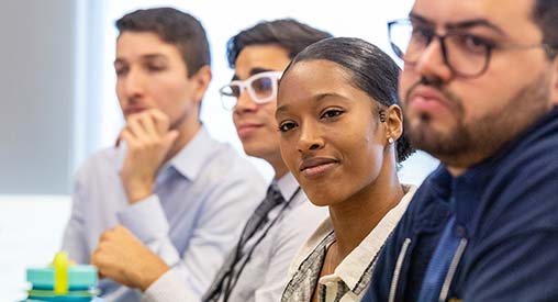 Four students listen to a lecture