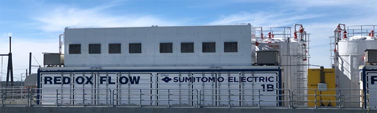 Large battery enclosures and equipment inside a gated structure.