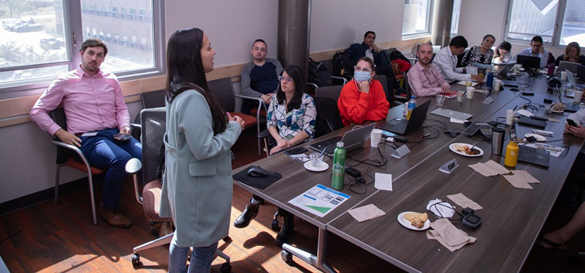 Group of people in conference room listen to presentation.