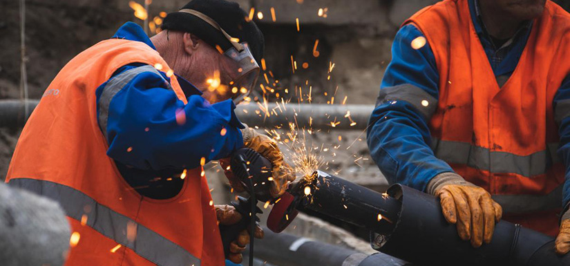 Two people welding.