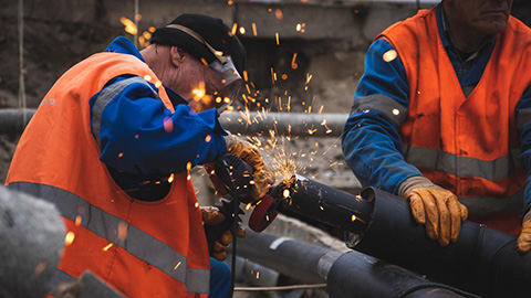 Two people welding.