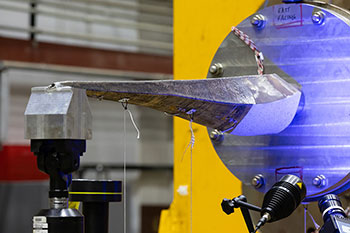 3D-printed stainless steel tidal turbine spar undergoing testing at NREL