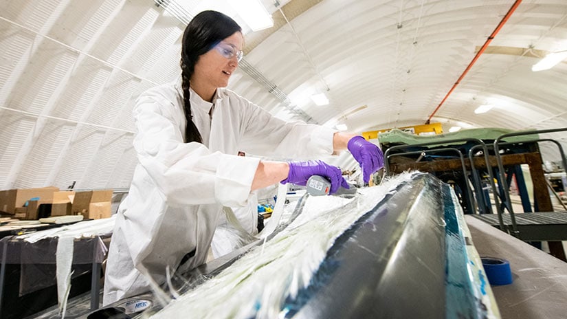 Person working inside the Composites Manufacturing Education and Technology Facility