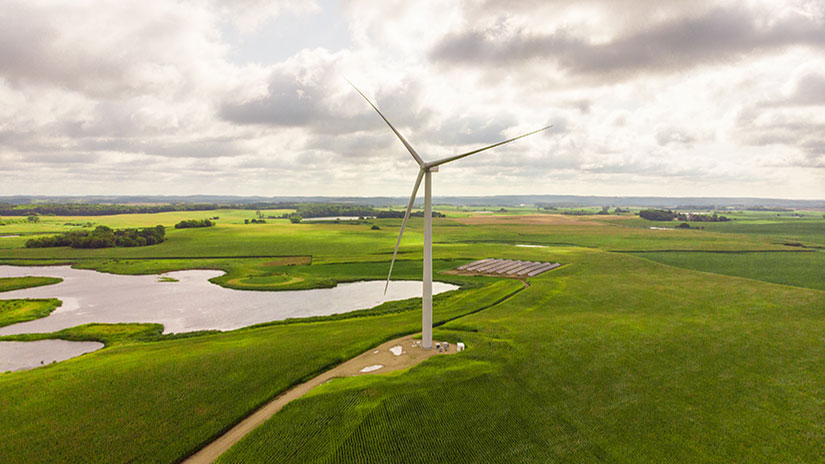 A wind turbine in a grassy field.