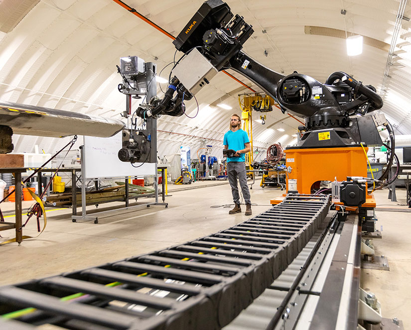 Man controls large robotic arm