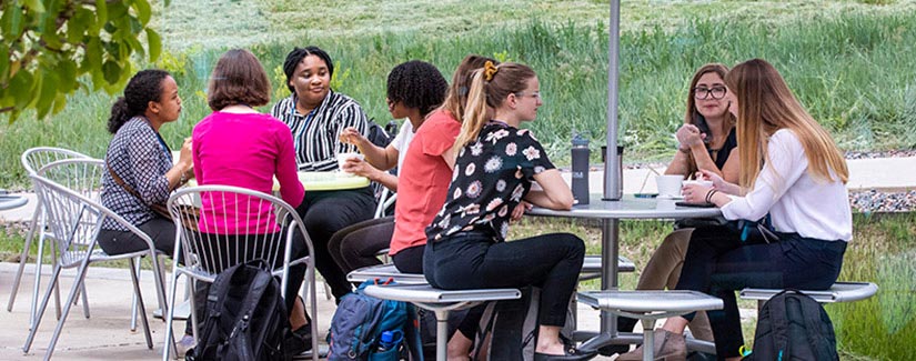 People sitting outside at tables.