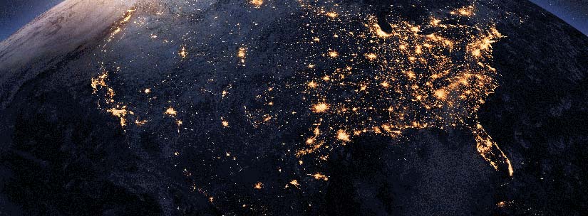 Satellite view of the entirety of the U.S. at night time, showing the bright city lights.