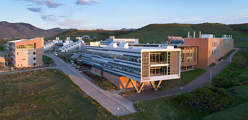 A series of buildings set against the mountains.