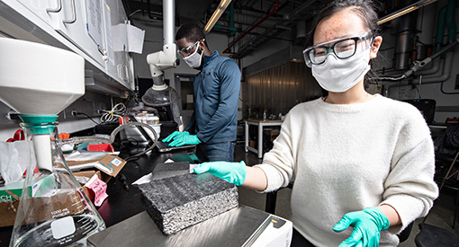 Two postdoc researchers in a lab at NREL.