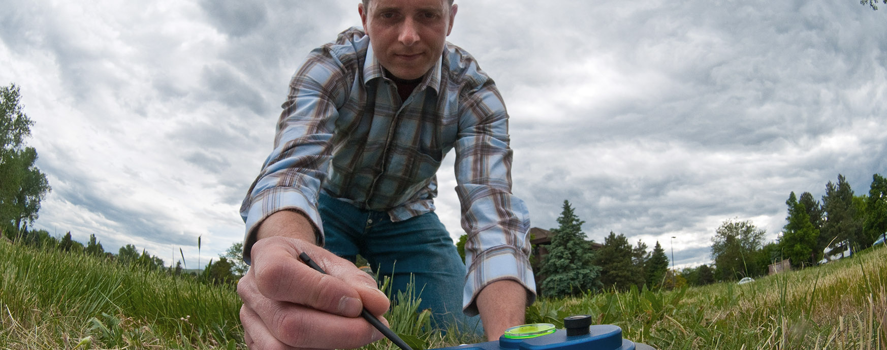 A man collecting soil samples.