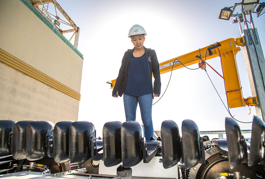 A mechanical engineer inspects turbine blades.