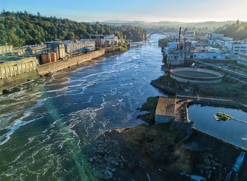 Aerial photo of a water power plant and bridges on a river.