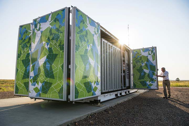 2018-09-photo-03 Flex manufactured battery enclosure decorated in green and blue geometric shapes at the Battery Energy Storage System site at NREL's National Wind Technology Center.