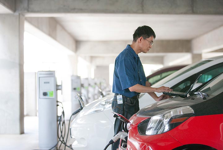 3-201806-39234 A researcher analyzes data for an electric vehicle plugged into Level 2 electric vehicle supply equipment