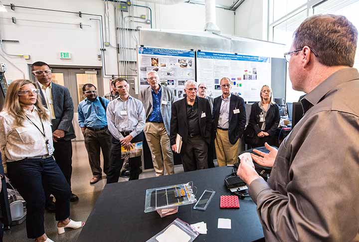 6-201806-50935 A researcher explains internal short circuit research to USCAR directors on a tour of the ESIF at NREL