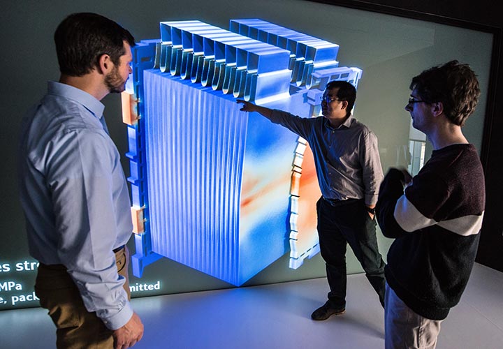 energy-storage-41716-720w Three researchers looking at a 3-D model of a lithium-ion battery and the battery's response to mechanical-electrical-thermal failure.