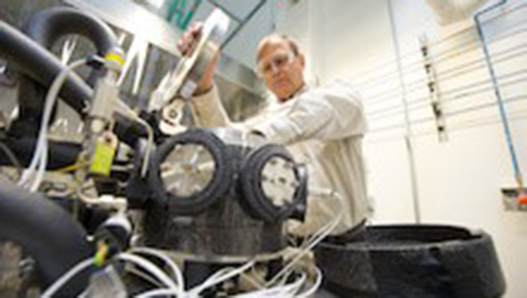 thsc-201804-2 PA researcher works on the sensor test apparatus for testing hydrogen safety sensors in NREL's Hydrogen Sensor Test Lab